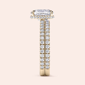 "Elegant 14K yellow gold engagement ring with radiant cut diamond, halo of smaller diamonds, and a diamond-studded band."