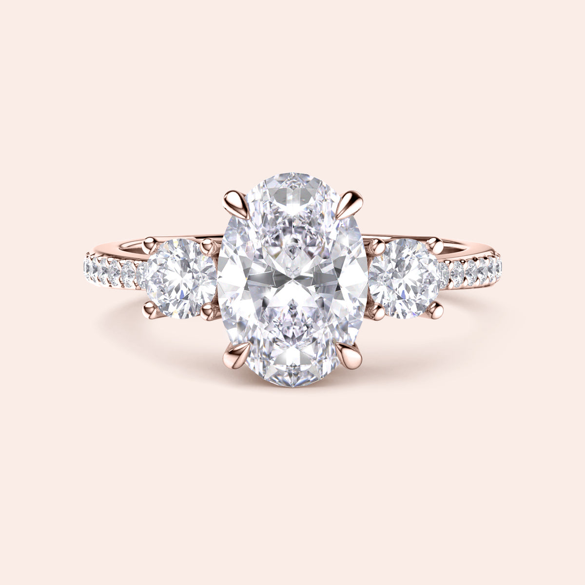 Oval diamond engagement ring in 14K rose gold, featuring a central oval diamond with side round stones and pave accents.