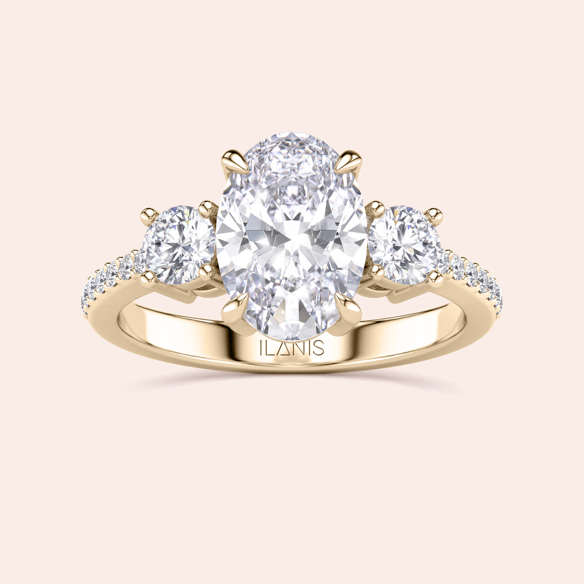 Three-stone oval engagement ring with diamond center stone in 14K or 18K gold, featuring pave side stones for added sparkle.