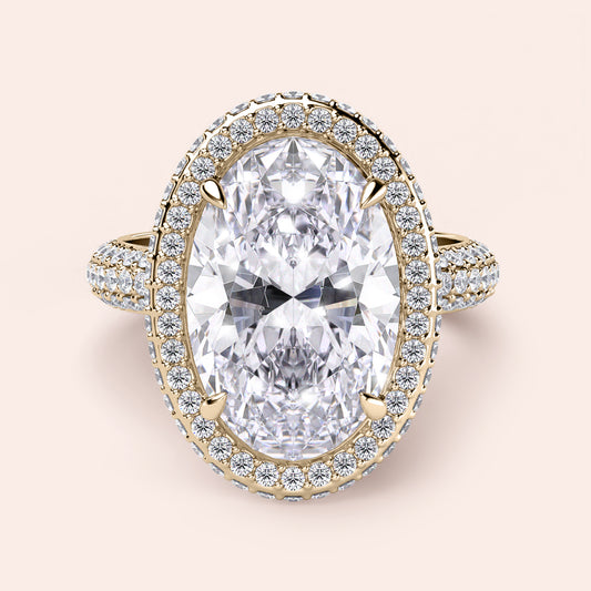 Luxurious 14K or 18K yellow gold engagement ring with oval diamond and halo of smaller diamonds, perfect for your special moment.