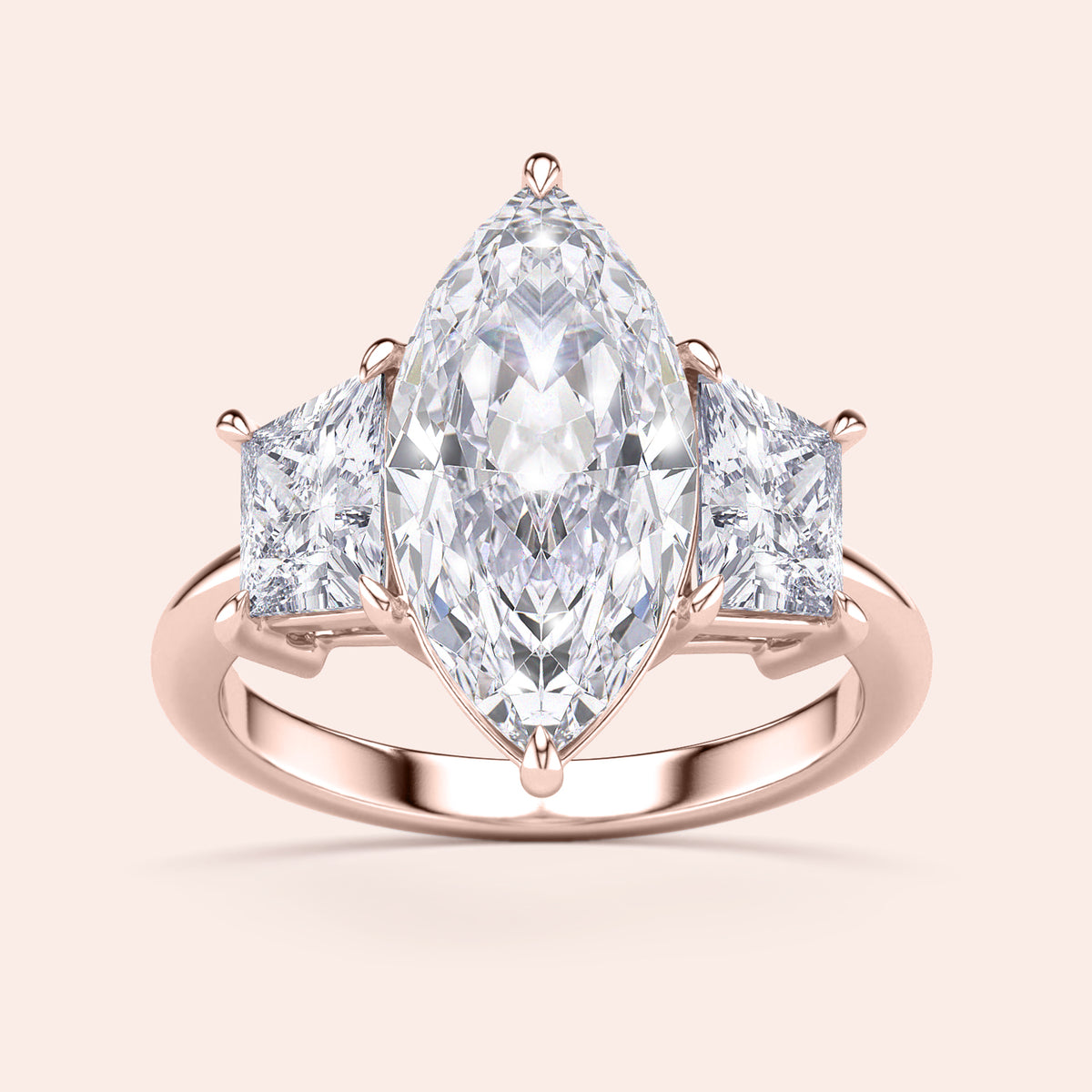 Rose gold engagement ring featuring a marquise-cut diamond and two princess-cut diamonds, available in 14K, 18K, or platinum.