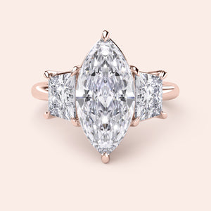 Exquisite three-stone engagement ring in 14K or 18K rose gold, featuring marquise and square-cut diamonds for a stunning look.