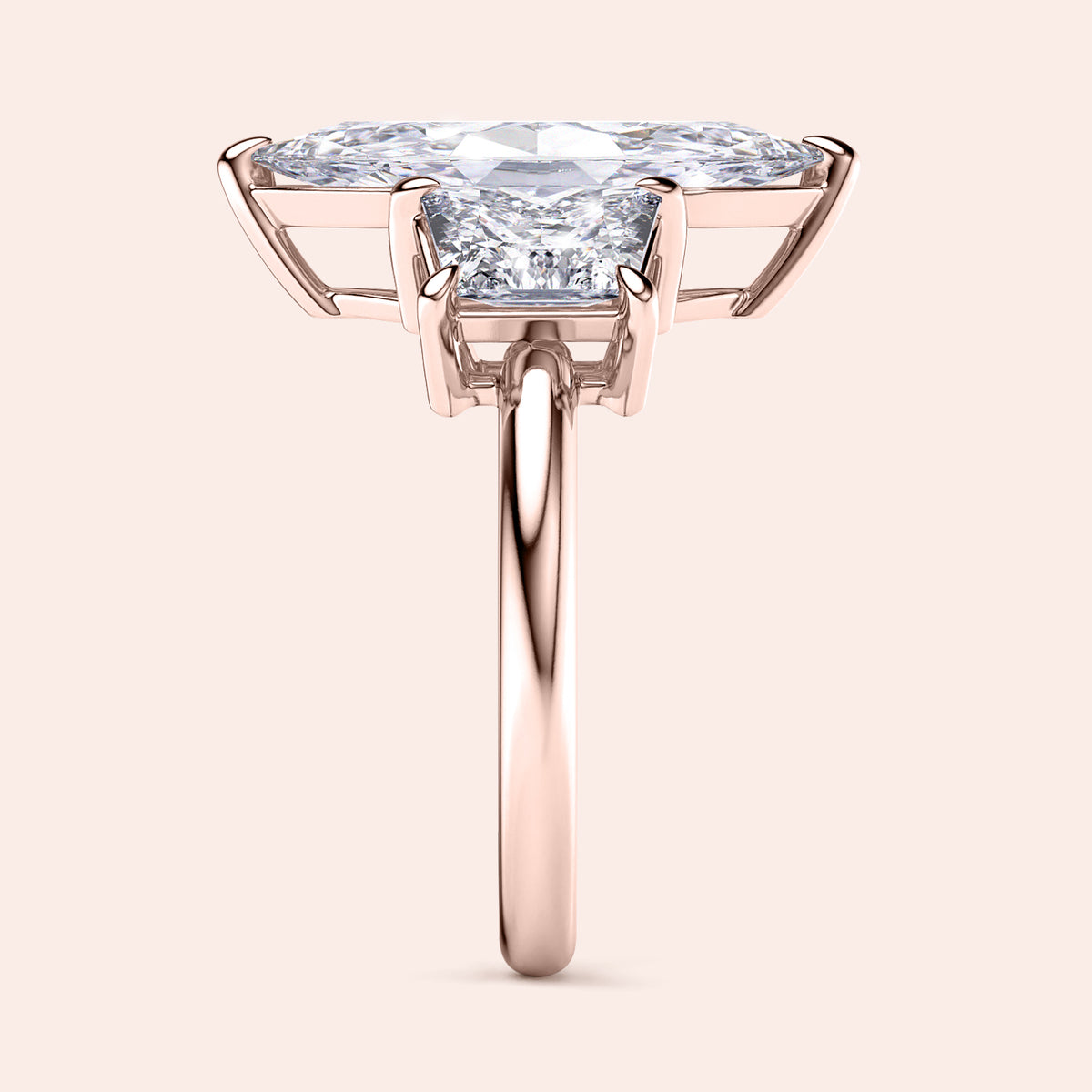 Elegant 14K rose gold engagement ring featuring a jade marquise cut and three trapezoid stones, perfect for timeless romance.