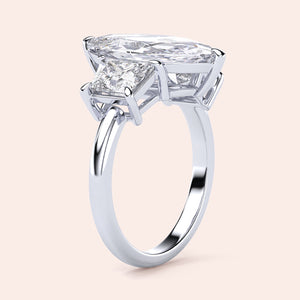 "Elegant 14K gold engagement ring featuring a marquise jade and three stone trapezoid diamonds in a secure setting."