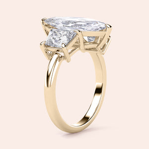 "Elegant yellow gold engagement ring featuring jade marquise and three stone trapezoid design, available in 14K or 18K."
