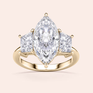 Elegant 14K/18K gold engagement ring featuring a marquise-cut jade centerpiece and two trillion-cut diamonds, perfect for special moments.