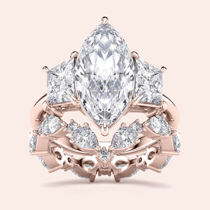 Elegant emerald-cut diamond engagement ring in 14K rose gold, worn on model, featuring a stunning pave band for a timeless look.