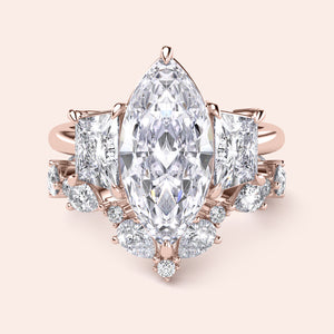 Elegant emerald-cut diamond engagement ring in 14K rose gold, worn on model, featuring a stunning pave band for a timeless look.