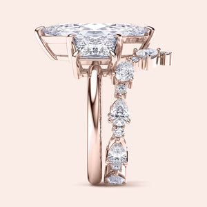 Elegant emerald-cut diamond engagement ring in 14K rose gold, worn on model, featuring a stunning pave band for a timeless look.