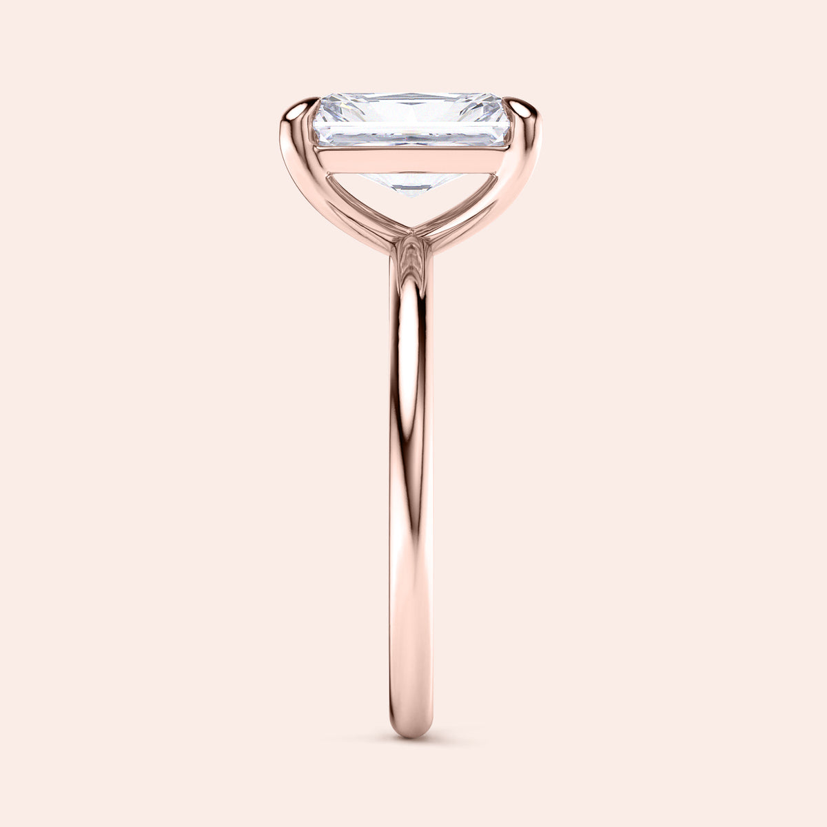 "Elegant 14K rose gold engagement ring featuring an emerald-cut diamond in a minimalist design. Perfect for special occasions."