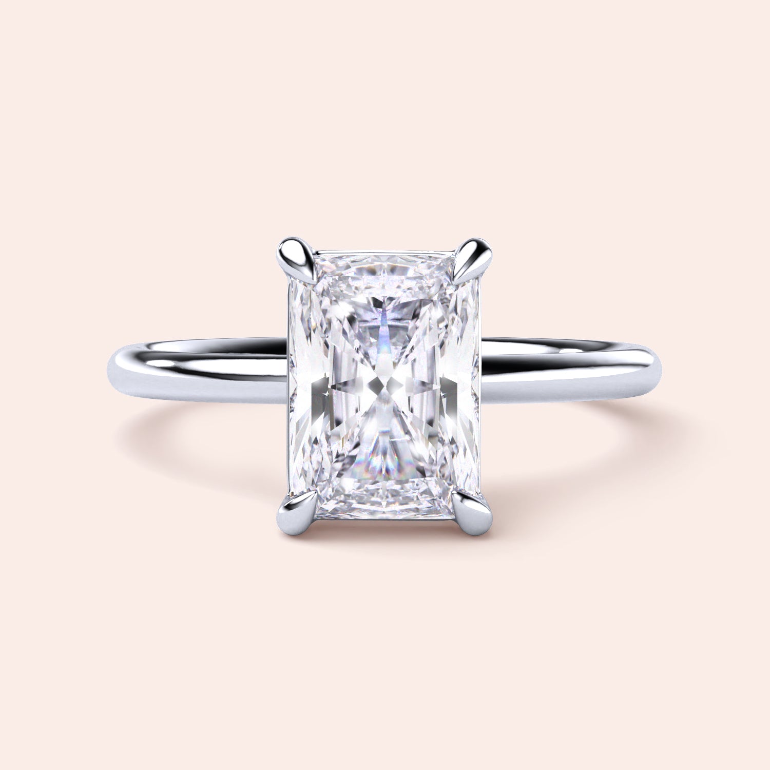 Radiant rectangular diamond solitaire ring in 14K/18K white gold, showcasing a timeless and elegant design.
