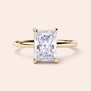 Radiant cut diamond solitaire ring in yellow gold setting, available in 14K, 18K, and platinum options. Elegant design display.