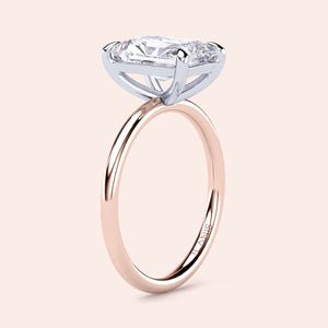 Two-tone 14K white and rose gold diamond ring featuring a stunning marquise-shaped diamond in a classic solitaire design. 