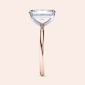 Two-tone 14K/18K white and rose gold diamond ring featuring an elegant emerald-cut gem in a classic solitaire design. 