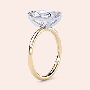 Two-tone 14K/18K white and yellow gold engagement ring featuring a radiant-cut diamond, elegant and timeless design. 