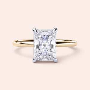 Two-tone 14K/18K white and yellow gold diamond ring featuring a radiant-cut center stone in a classic solitaire design. 
