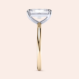 Two-tone 14K/18K gold ring featuring an emerald-cut diamond in classic solitaire design, blending white and yellow gold. 