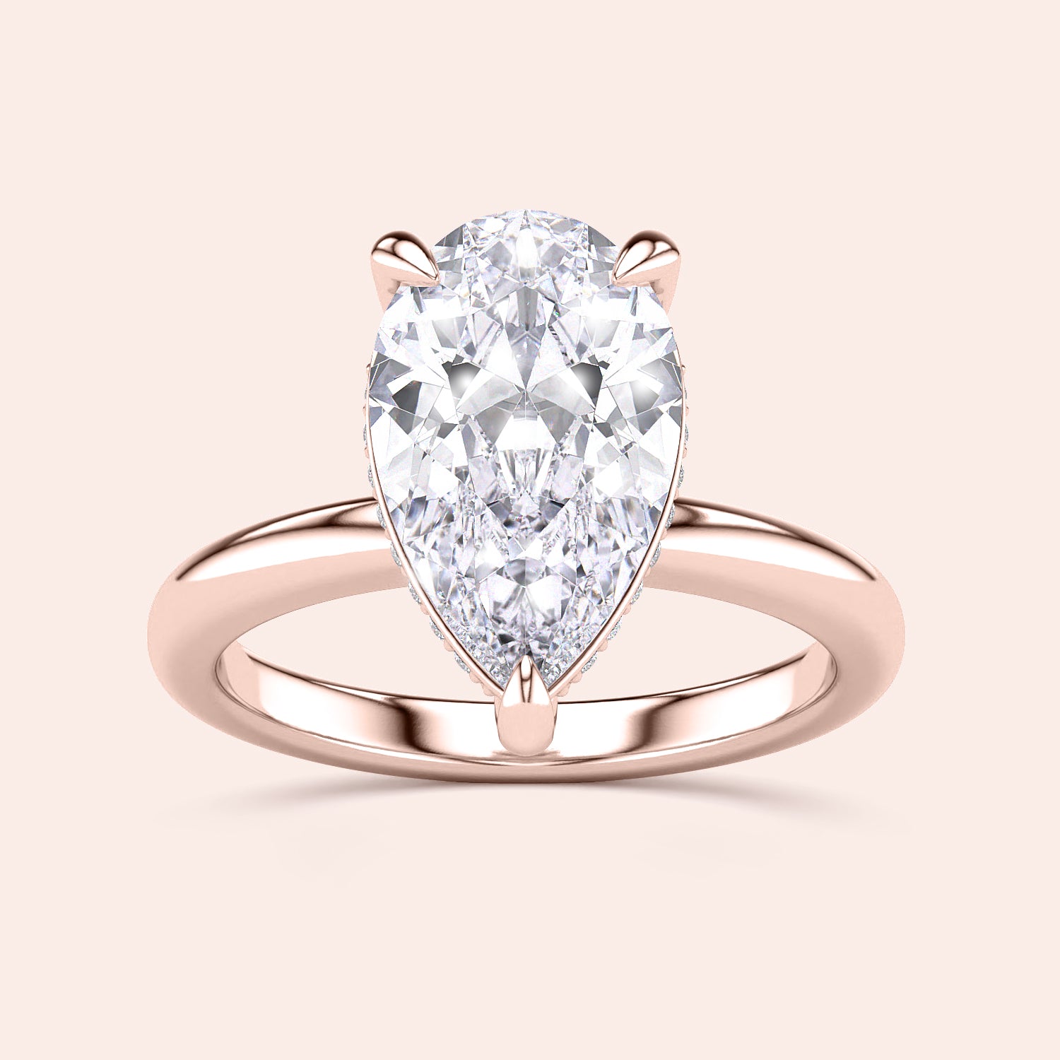 Elegant 14K rose gold engagement ring featuring a pear-shaped diamond, showcasing sleek prong details in a close-up view. |


#14KRecycledRoseGold
#18KRecycledRoseGold



