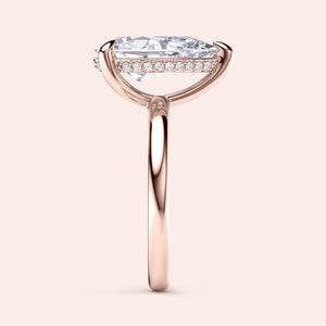 Side view of a stunning pear-cut diamond engagement ring with accent diamonds on a sleek rose gold band, available in 14K, 18K, and platinum. 