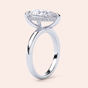 Elegant pear-shaped diamond engagement ring with hidden halo and plain band, crafted in 14K or 18K white gold or platinum. 