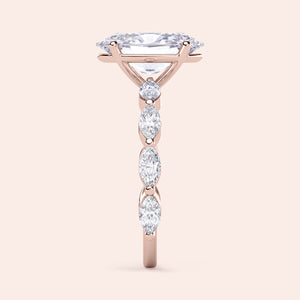 Elegant 14K rose gold engagement ring with a marquise diamond and a large round-cut diamond centerpiece.
