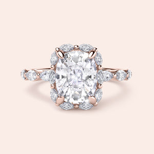Exquisite rose gold engagement ring featuring a cushion-cut diamond with a halo of marquise diamonds in 14K or 18K.
