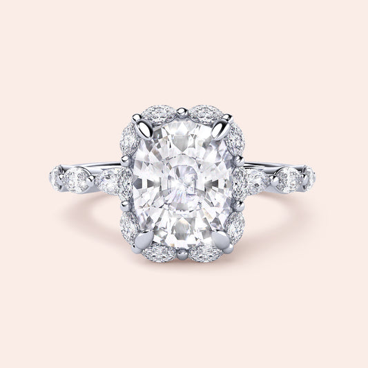 Elegant cushion cut diamond ring with marquise halo in 14K white gold, featuring oval-shaped diamond accents.