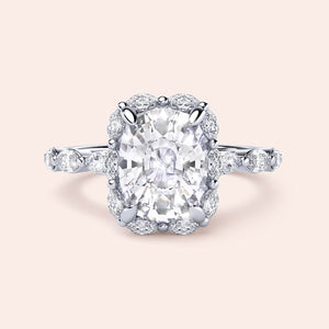 Elegant cushion cut diamond ring with marquise halo in 14K white gold, featuring oval-shaped diamond accents.
