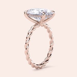 Elegant rose gold twisted band engagement ring in 14K and 18K, featuring a marquise diamond and intricate design detail.