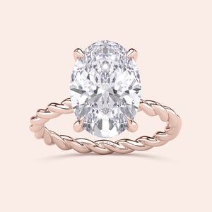 Rose gold twisted band engagement ring featuring an oval-shaped diamond, available in 14K, 18K, or platinum metal types.