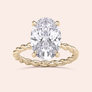 Gold twisted band ring featuring an oval-shaped diamond, available in 14K, 18K, or platinum, shown unworn.