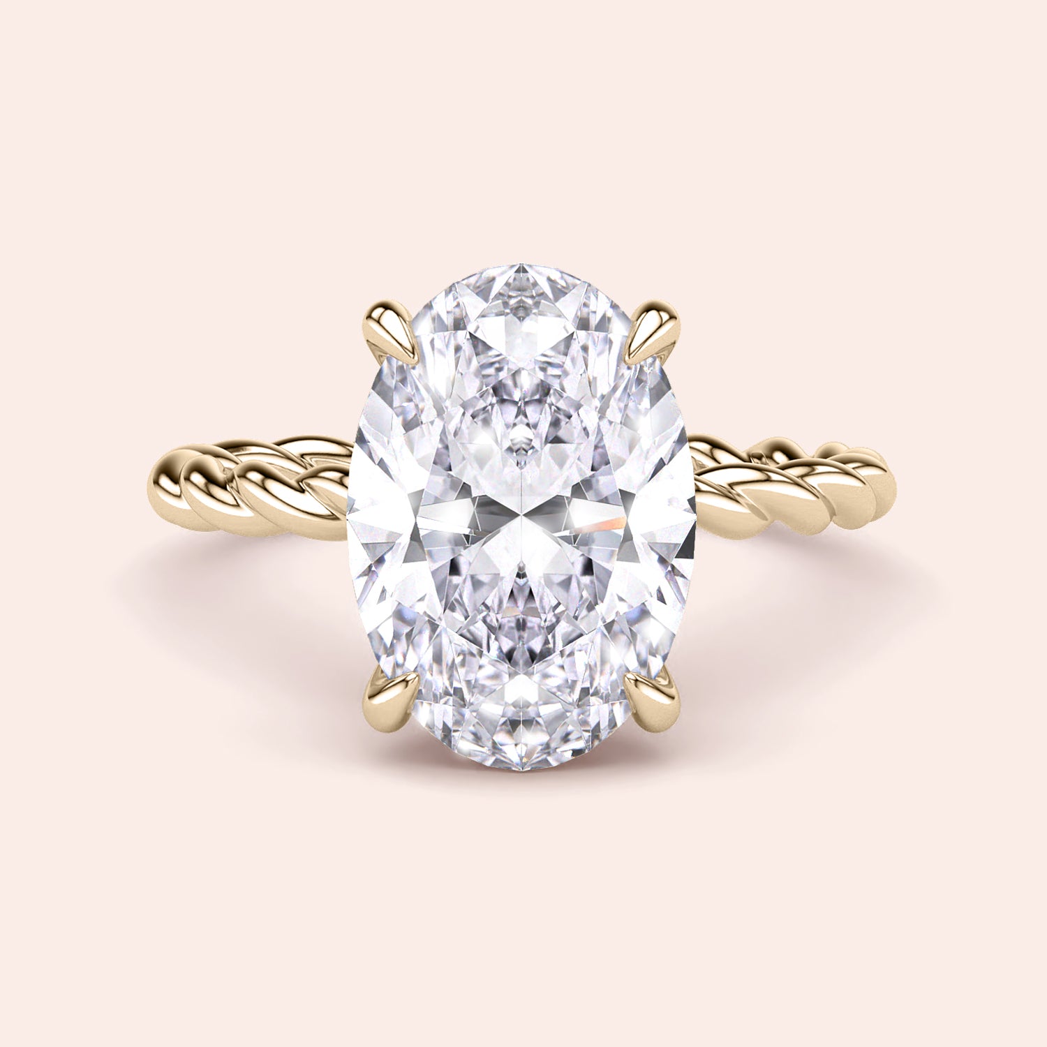 Elegant oval-cut diamond engagement ring in a twisted 14K gold band, featuring a radiant prong setting for a timeless look.