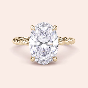 Elegant oval-cut diamond engagement ring in a twisted 14K gold band, featuring a radiant prong setting for a timeless look.