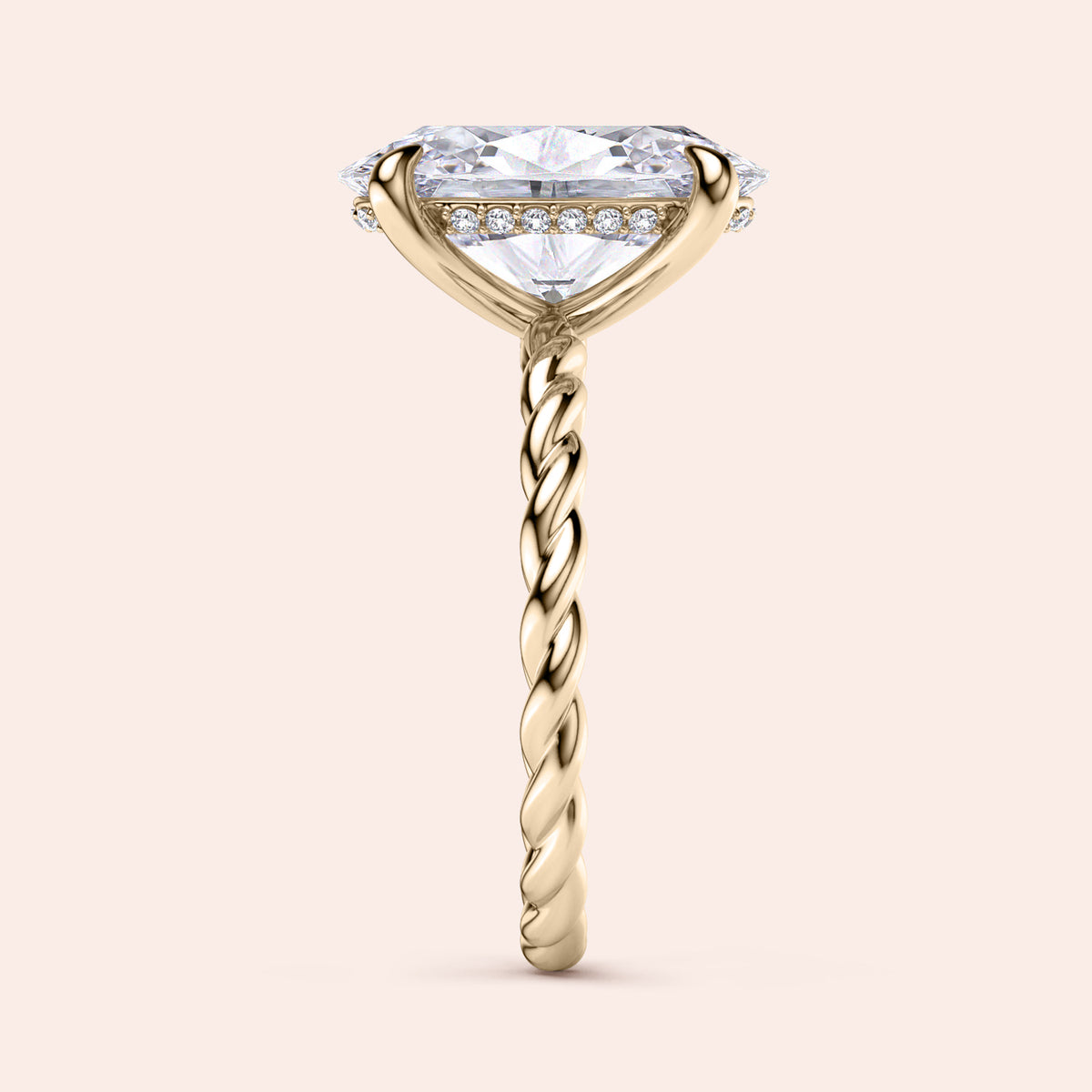 Elegant oval twisted band engagement ring in 14K or 18K gold or platinum, featuring a halo of diamonds beneath the center stone.