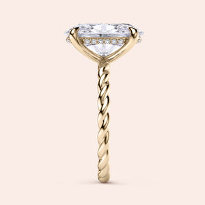 Elegant oval twisted band engagement ring in 14K or 18K gold or platinum, featuring a halo of diamonds beneath the center stone.