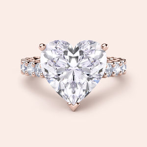 Exquisite heart-shaped diamond engagement ring in 14K rose gold, featuring a large central diamond and sparkling accents.