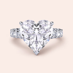 Exquisite heart-shaped diamond ring in 14K or 18K gold or platinum, featuring a brilliant heart-cut diamond and side diamonds.