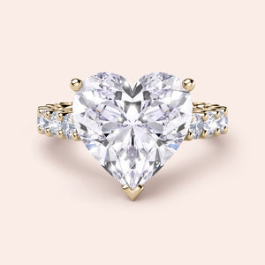 Heart-shaped diamond ring in 14K yellow gold with hidden halo and side diamonds, perfect for engagements or special occasions.