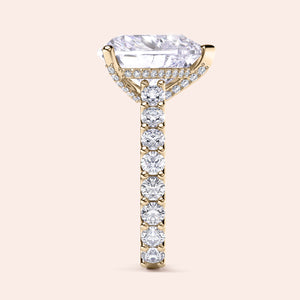 Elegant yellow gold engagement ring with an elongated cushion diamond and an accent diamond band. Available in 14K, 18K, or platinum.