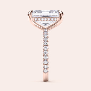 Elegant 14K rose gold engagement ring featuring a radiant cut diamond on a pave band, beautifully worn on a model.
