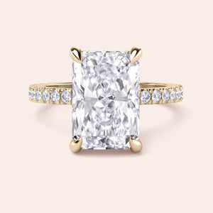Radiant-cut diamond engagement ring with side stone accents in 14K yellow gold, displayed on a neutral background.