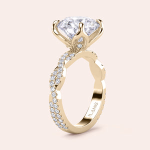 Radiant-cut diamond engagement ring with side stone accents in 14K yellow gold, displayed on a neutral background.