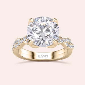 Radiant-cut diamond engagement ring with side stone accents in 14K yellow gold, displayed on a neutral background.