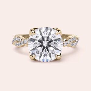 Radiant-cut diamond engagement ring with side stone accents in 14K yellow gold, displayed on a neutral background.