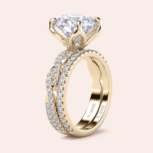 Radiant-cut diamond engagement ring with side stone accents in 14K yellow gold, displayed on a neutral background.