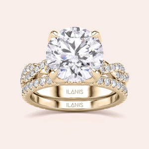 Radiant-cut diamond engagement ring with side stone accents in 14K yellow gold, displayed on a neutral background.