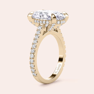 Radiant-cut diamond engagement ring with side stone accents in 14K yellow gold, displayed on a neutral background.