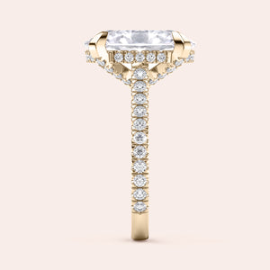 Radiant-cut diamond engagement ring with side stone accents in 14K yellow gold, displayed on a neutral background.
