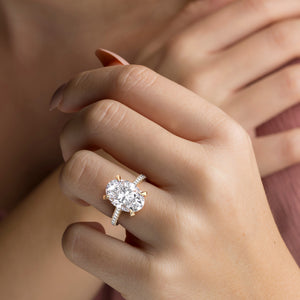 Radiant-cut diamond engagement ring with side stone accents in 14K yellow gold, displayed on a neutral background.
