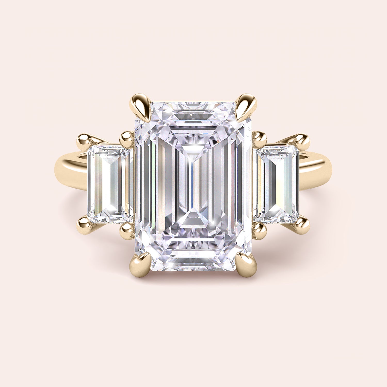Radiant-cut diamond engagement ring with side stone accents in 14K yellow gold, displayed on a neutral background.